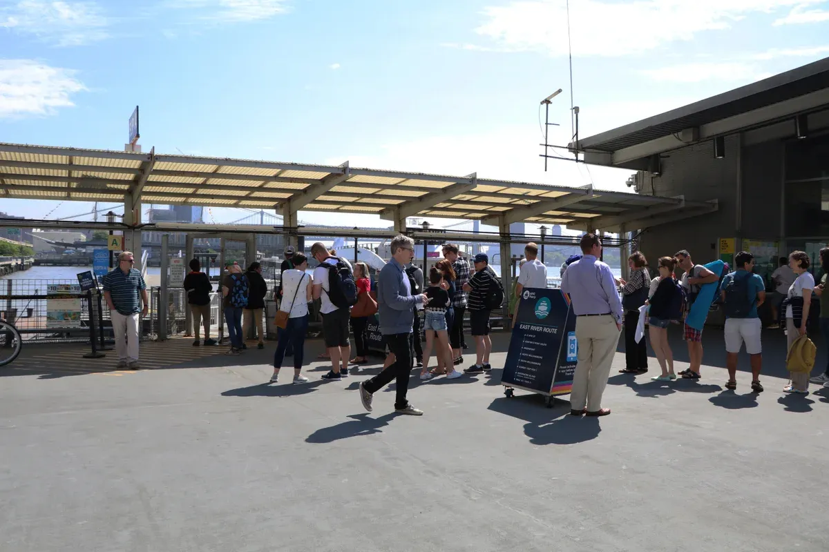 Passengers queueing at the Pier 11 Wall Street ferry landing, a starting point for a New York architecture boat tour